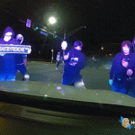 Video shows officer trapped inside cruiser as vandals smash windshield